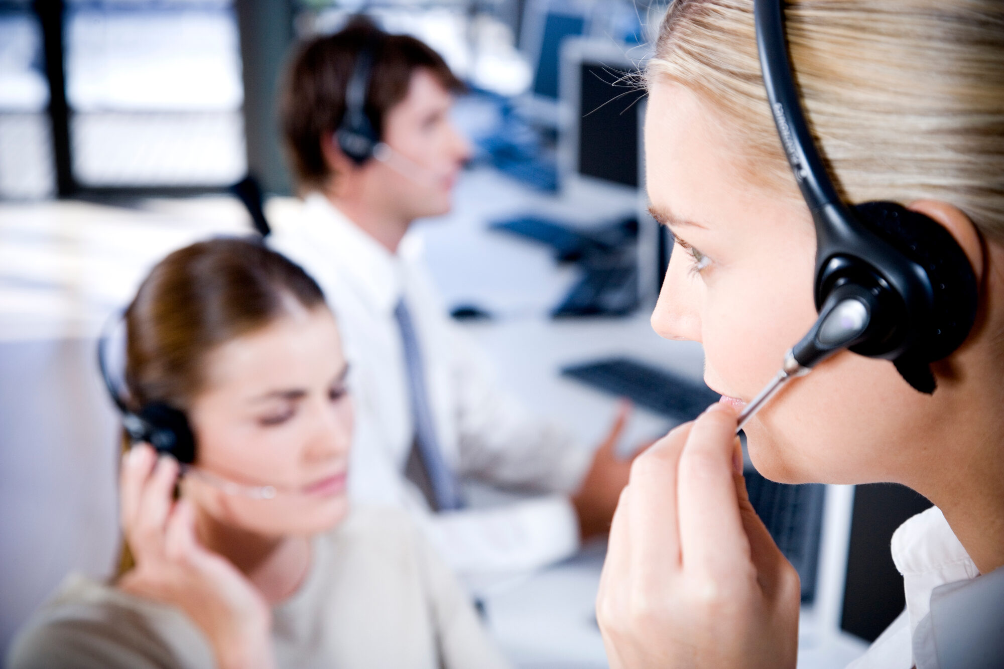 Call center agents at their desks on calls